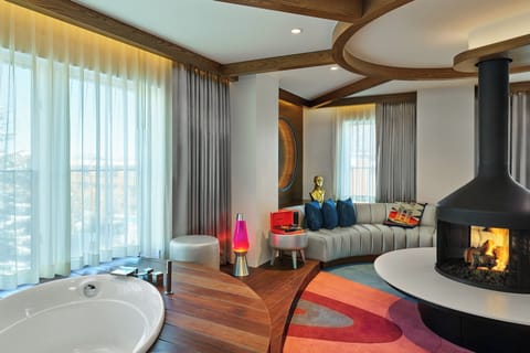 Presidential Suite, 1 King Bed, Fireplace | Living room | 50-inch flat-screen TV with cable channels, TV, books