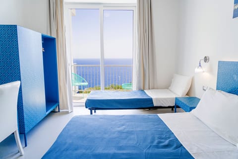 Family Quadruple Room, Sea View | Minibar, in-room safe, individually decorated, desk