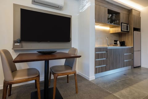 Luxury Studio Suite | Living area | Flat-screen TV, heated floors