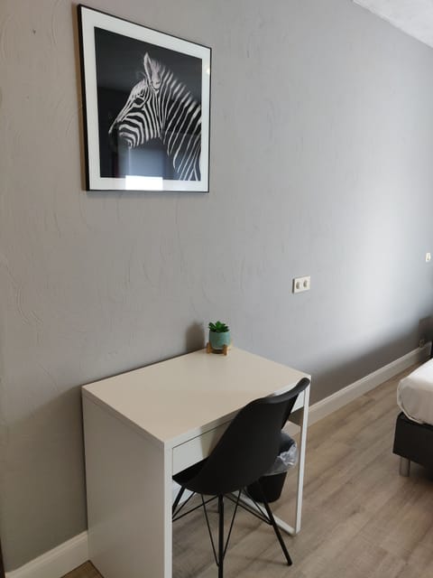 Desk, laptop workspace, blackout drapes, iron/ironing board