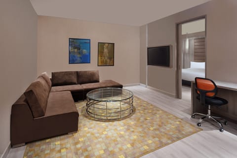 Club Suite, 1 Bedroom (Savvy) | Living room | 49-inch LED TV with digital channels, TV