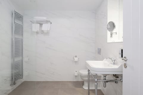 Shower, designer toiletries, hair dryer, bathrobes