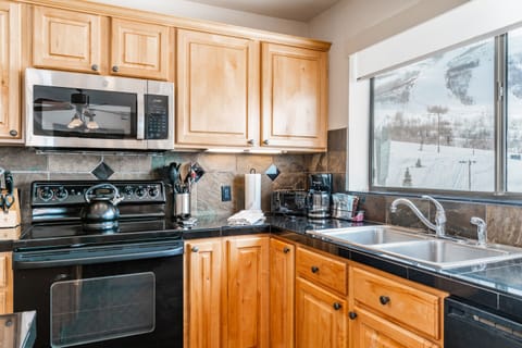 3-Bedroom Condominium #32 | Private kitchen | Full-size fridge, microwave, stovetop, dishwasher