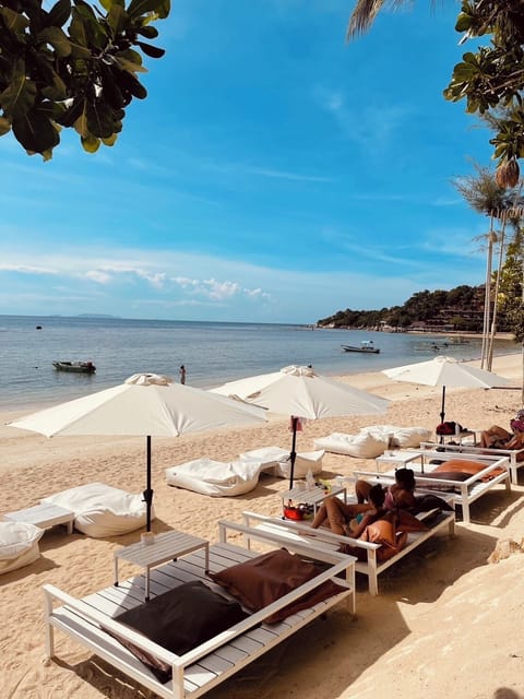 On the beach, white sand, sun loungers, beach towels