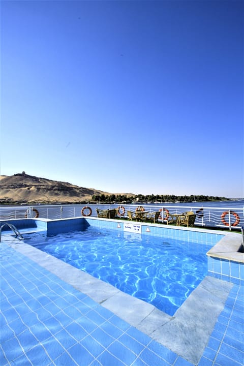 Outdoor pool, a rooftop pool, pool umbrellas, sun loungers