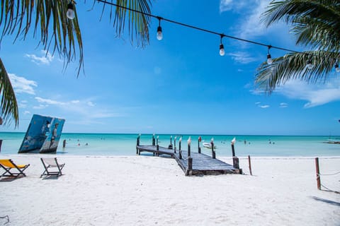 On the beach, white sand, sun loungers, beach towels