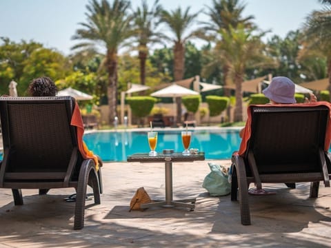 Outdoor pool, open 7:00 AM to 9:00 PM, pool umbrellas, sun loungers