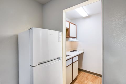 Full-size fridge, microwave, stovetop, dining tables