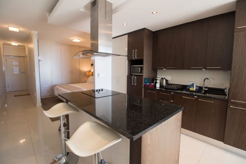 Studio, 1 King Bed | Private kitchen | Full-size fridge, microwave, stovetop, dishwasher