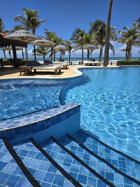 Outdoor pool, open 8 AM to 8 PM, pool umbrellas, sun loungers