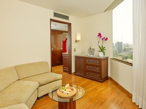 Suite, 1 King Bed | Living area | 32-inch LCD TV with cable channels, TV