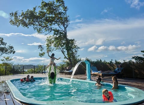 Seasonal outdoor pool, a waterfall pool, pool umbrellas, sun loungers