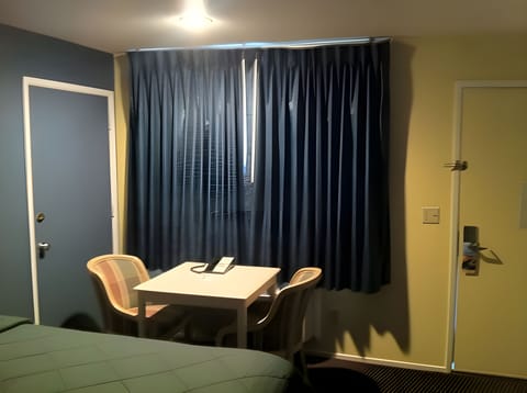 Desk, laptop workspace, blackout drapes, iron/ironing board