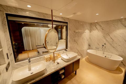 Luxury Suite | Bathroom | Rainfall showerhead, designer toiletries, hair dryer, bathrobes