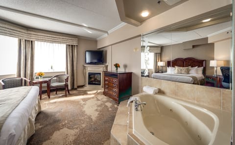 King Suite with Jetted Tub | Premium bedding, down comforters, in-room safe, individually decorated