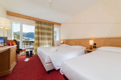 Classic Triple Room | Minibar, in-room safe, desk, blackout drapes