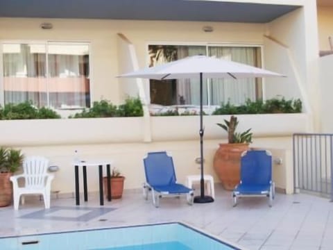 Seasonal outdoor pool, open 9:00 AM to 8:00 PM, pool umbrellas