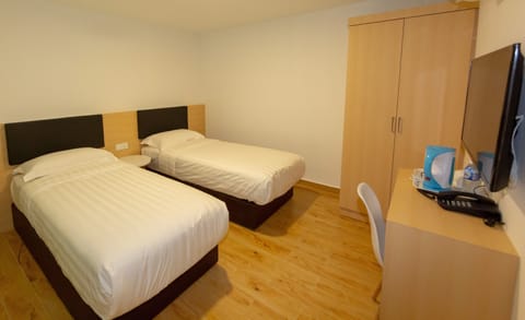 Executive Twin Room | Desk, blackout drapes, iron/ironing board, free WiFi