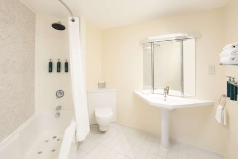 Junior Suite, 1 King Bed | Bathroom | Combined shower/tub, free toiletries, hair dryer, towels