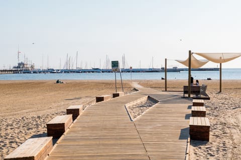 On the beach, white sand, sun loungers, beach umbrellas