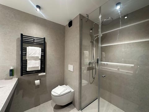 Shower, rainfall showerhead, towels, soap