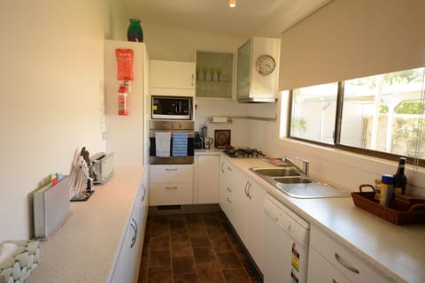 100 Oxide Street - Two Bedroom Cottage | Private kitchen | Full-size fridge, microwave, oven, stovetop