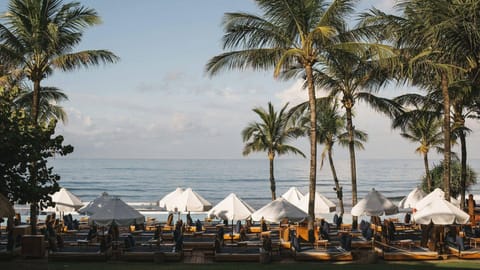 On the beach, white sand, beach cabanas, sun loungers