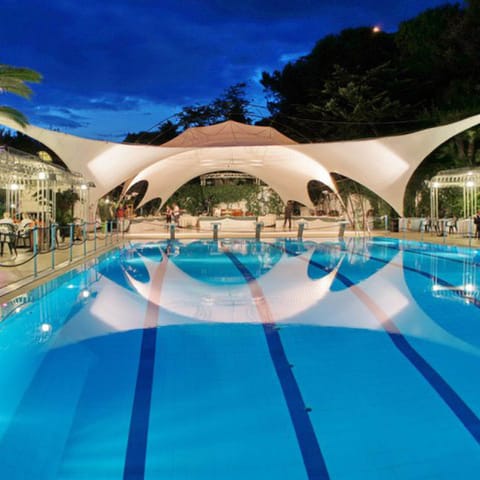 Seasonal outdoor pool, open 10:00 AM to 6:00 PM, pool umbrellas