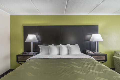 Premium bedding, desk, laptop workspace, blackout drapes