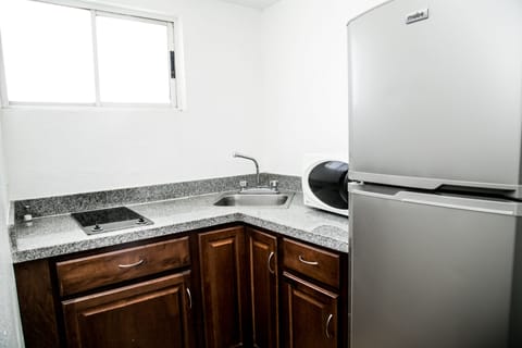 Comfort Room | Private kitchenette | Fridge, microwave, stovetop, cookware/dishes/utensils