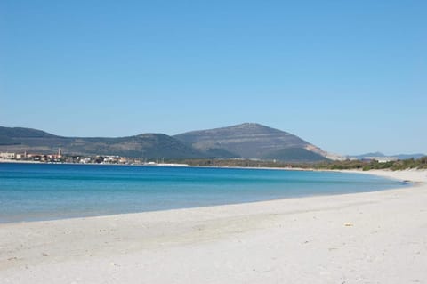 Beach nearby, white sand, beach umbrellas, beach towels