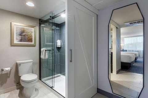 Suite, 2 Queen Beds | Bathroom | Combined shower/tub, designer toiletries, hair dryer, towels