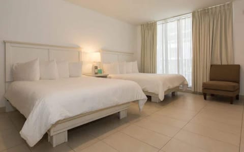 Suite, 1 Bedroom (2 Queens and 2 Doubles) | In-room safe, soundproofing, free WiFi, bed sheets