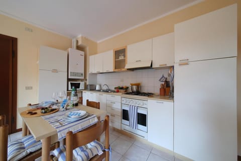 Family Apartment, 1 Bedroom (Petalo Bianco 100m from lake) | Private kitchen | Full-size fridge, microwave, oven, stovetop