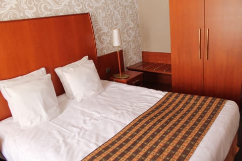 Standard Double Room | Minibar, in-room safe, desk, blackout drapes