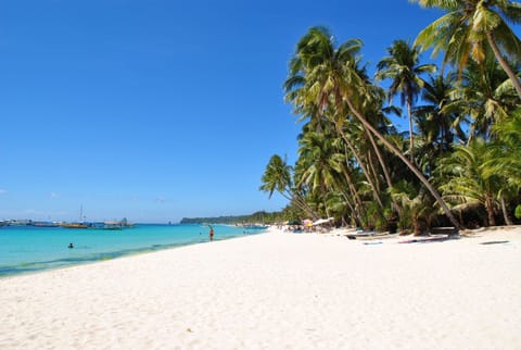 On the beach, white sand, sun loungers, beach umbrellas