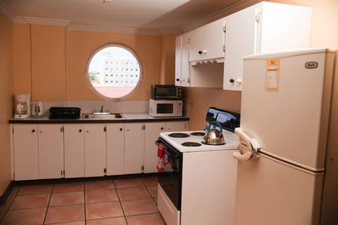 Suite, 1 King Bed | Private kitchenette | Microwave, coffee/tea maker, cookware/dishes/utensils