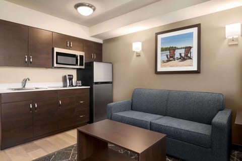 Suite, 1 Queen Bed, Non Smoking | Desk, laptop workspace, blackout drapes, iron/ironing board