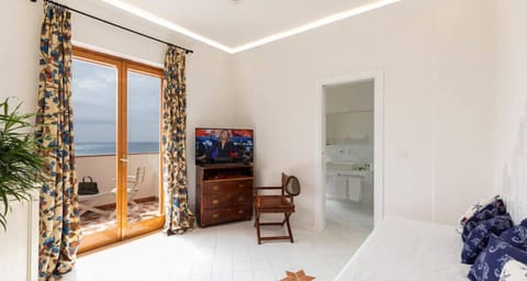 Deluxe Room, Balcony, Sea View | Minibar, in-room safe, desk, blackout drapes