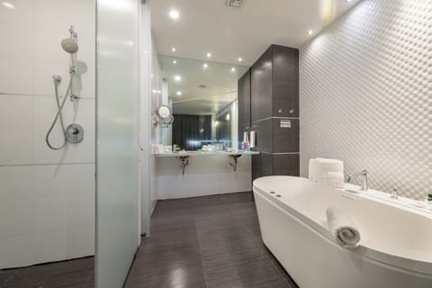 Suite, 1 King Bed | Bathroom | Shower, free toiletries, towels