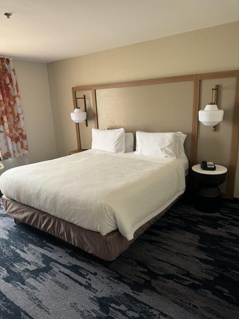 Premium bedding, desk, laptop workspace, blackout drapes