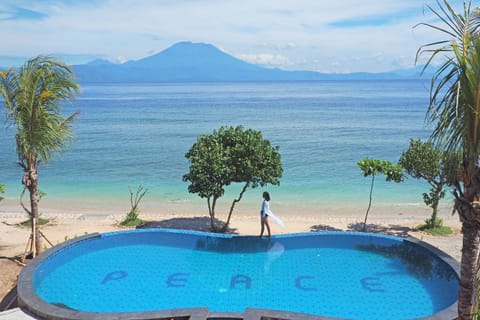 On the beach, white sand, sun loungers, beach towels