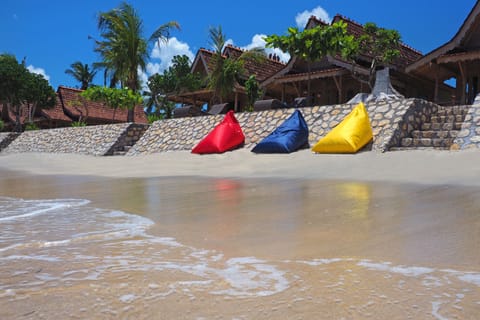 On the beach, white sand, sun loungers, beach towels