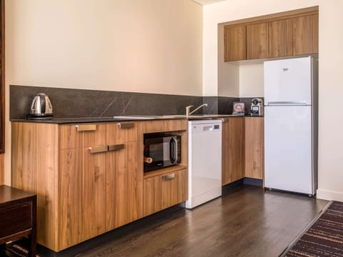 Apartment, 1 King Bed (Privilege) | Private kitchenette | Coffee/tea maker, electric kettle, eco-friendly cleaning products