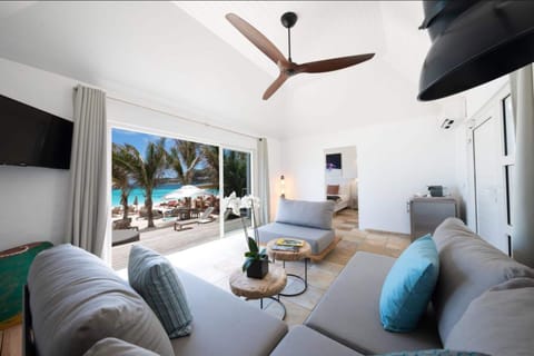 Suite, Beachfront | Living room | Flat-screen TV, iPod dock