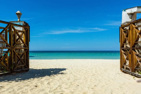 On the beach, white sand, sun loungers, beach umbrellas