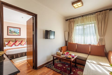 Suite | Living area | 26-inch LCD TV with cable channels, TV, first-run movies