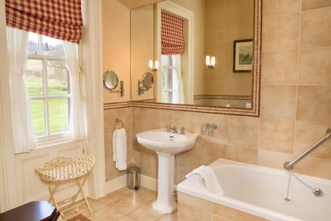 Designer toiletries, hair dryer, slippers, towels