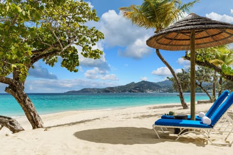 On the beach, white sand, sun loungers, beach umbrellas