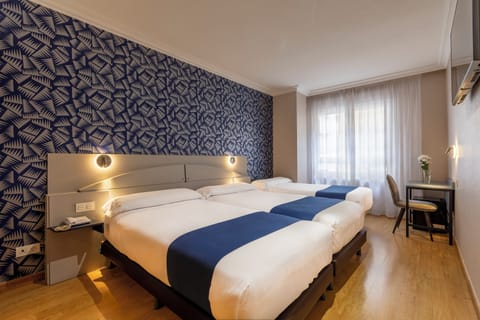 Triple Room | Minibar, in-room safe, individually decorated, individually furnished